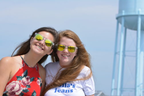 Two girls in sunglasses smiling 