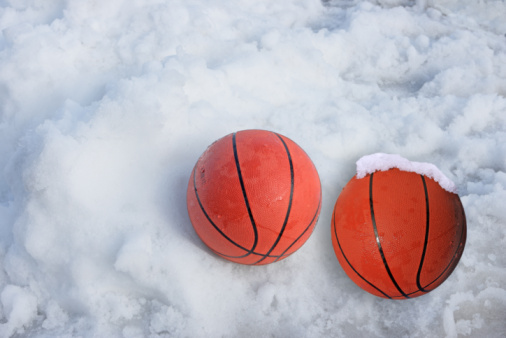 image of two basketballs in the snow