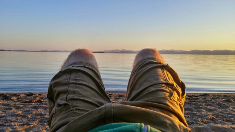 knees against a sunset at a beach