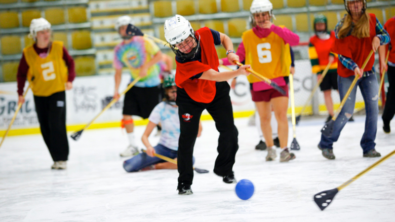 students playing broomball on ice