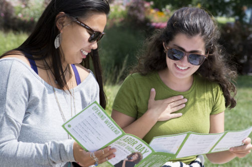 students reading WOW brochures