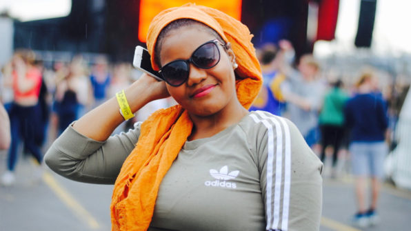 student smiling with concert in the background