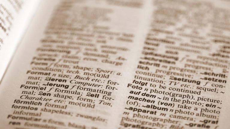 a close of of a page of a dictionary with lots of definitions