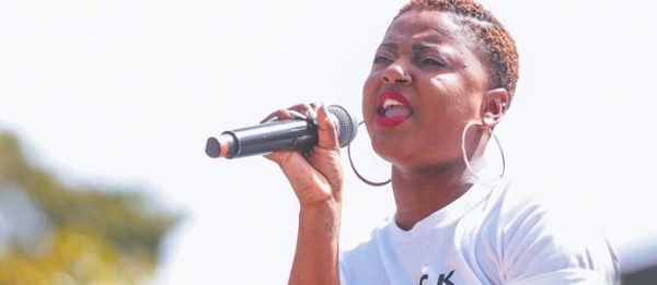 Porsche Nicole Kelly talking into a microphone