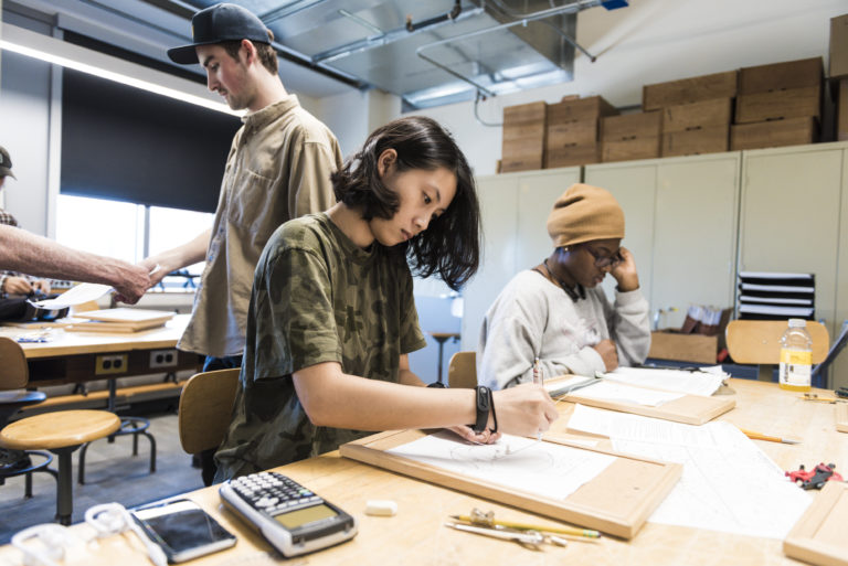 students in classroom working at desks