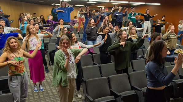 students dancing in a lecture hall