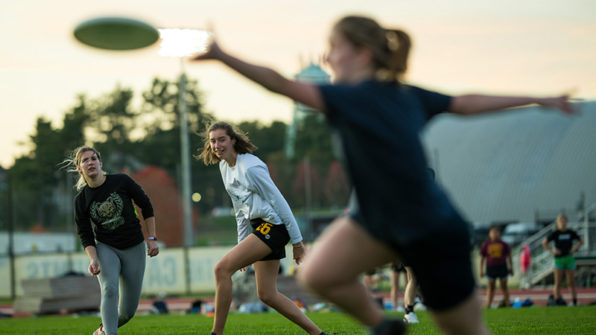 students catching frisbees