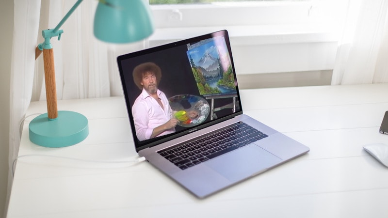 a laptop with images of bob ross painting on them