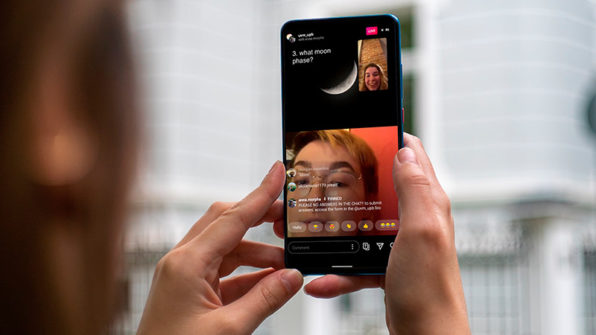 hands holding a phone watching instagram live