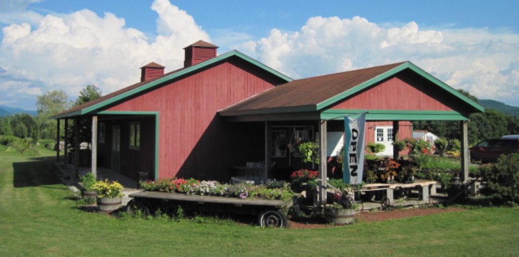 a red barn with green trim