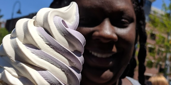 a woman holding ice cream close to the camera