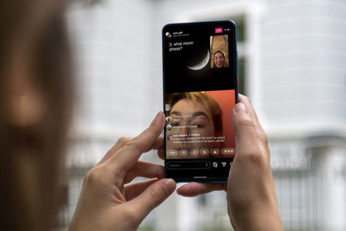 hands holding a phone watching an instagram live session