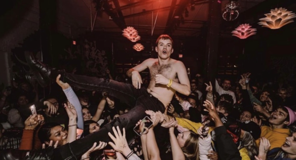 musician crowd surfing at a concert