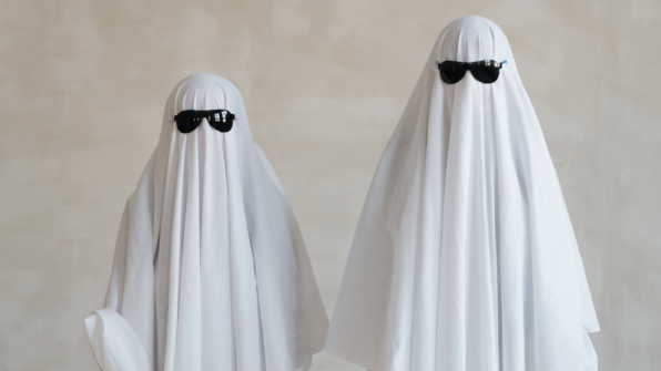 Two people dressed as ghosts