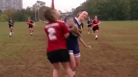 clip from the movie mean girls: Blond person playing laccrose checks two players while running the field with the ball in their stick