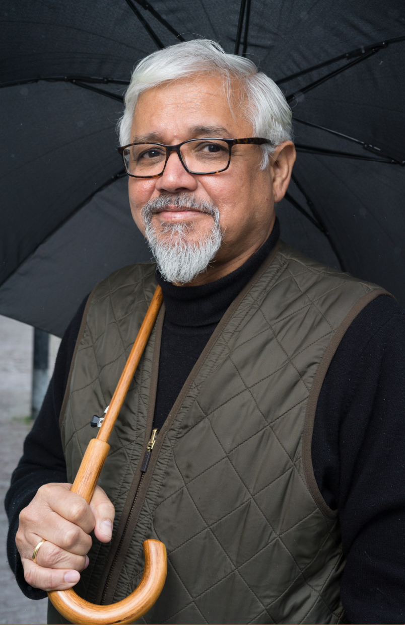 image of Author Amitav Ghosh with an umbrella