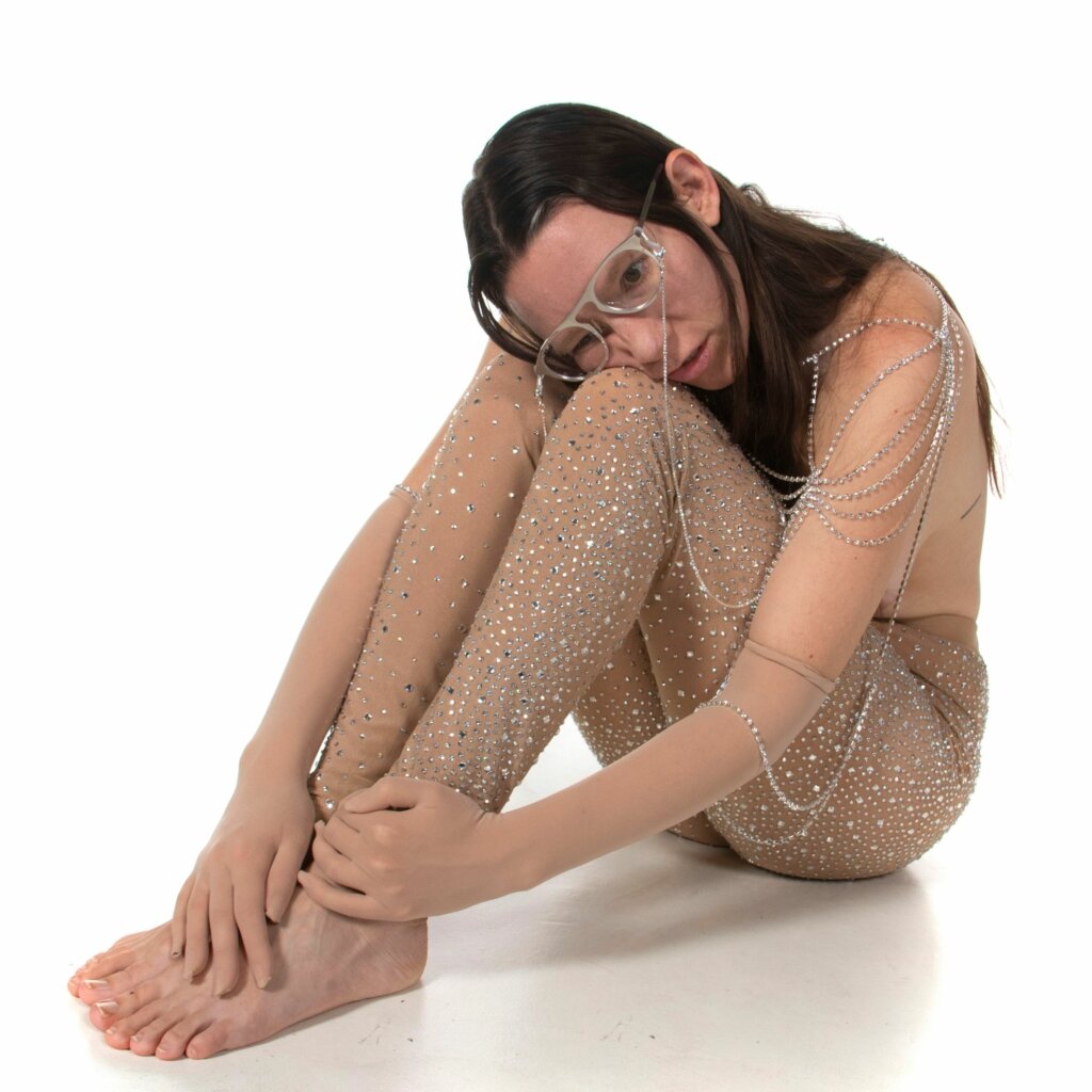 an image of the artist, boyfriend, sitting in a sheer outfit