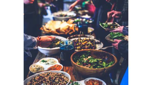 A variety of foods in wooden bowls sit on a table