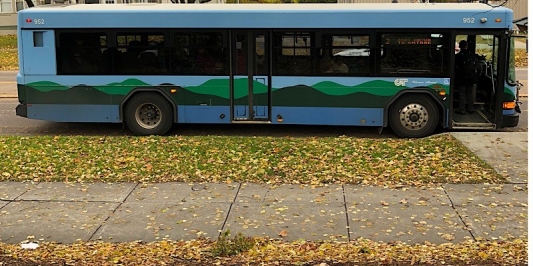 A GMT bus is stopped next to the road