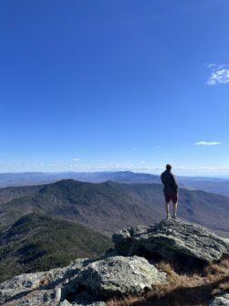 A man on the top of camel's hump